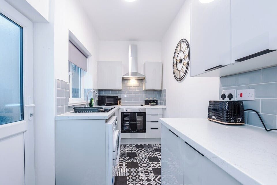 Spacious full kitchen with sleek, modern finishes.