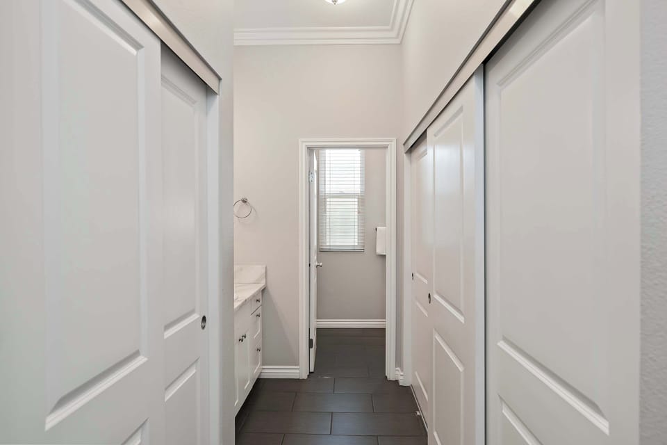 The hall bath showcases a large vanity & shower/tub combo