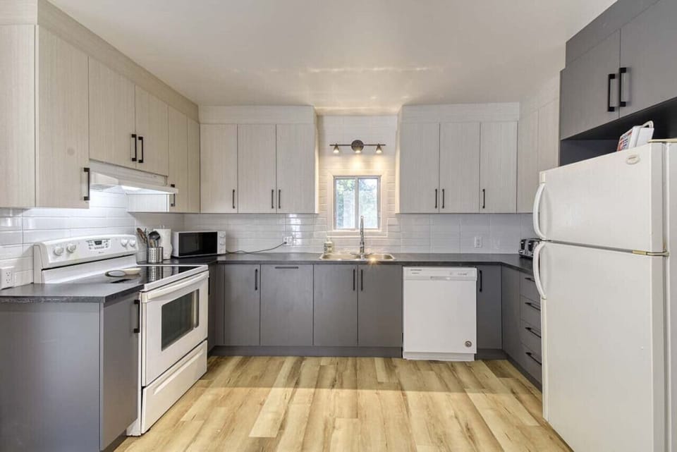 Modern kitchen with a clean white and grey theme—sleek design meets functional elegance.