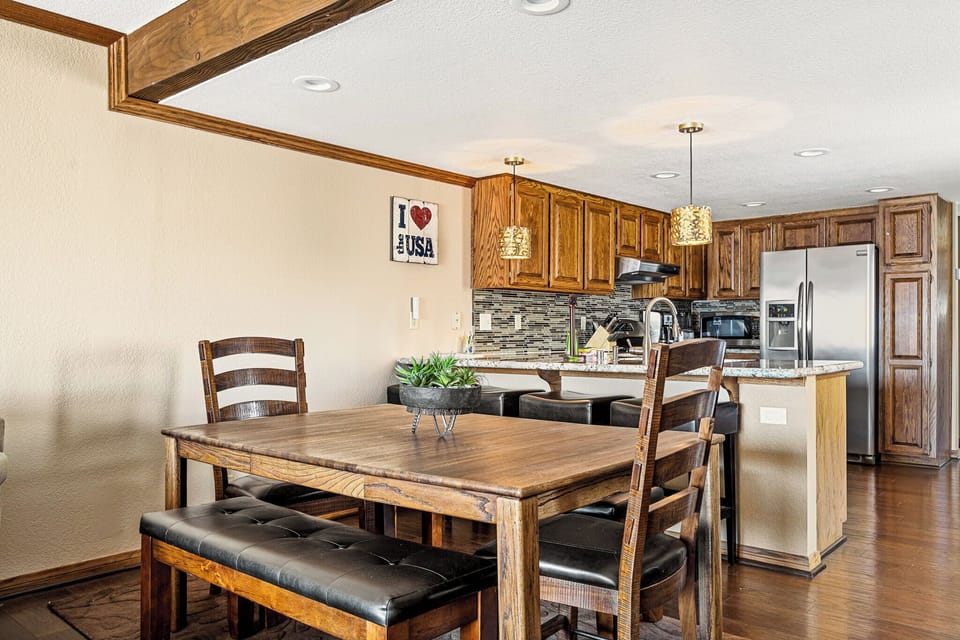 Dining table with seating for 8, additional barstools right behind.