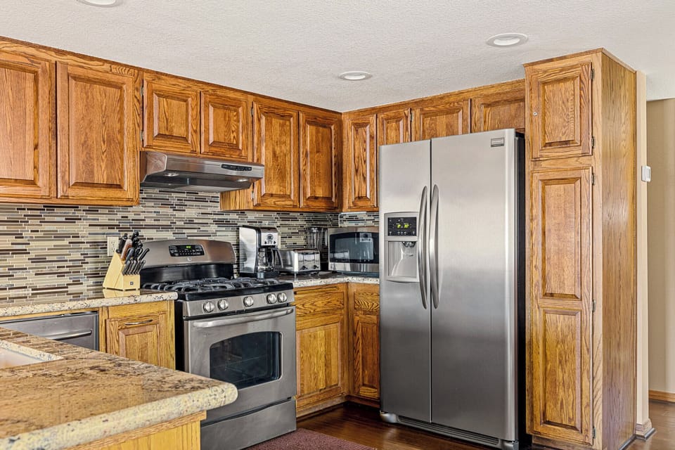 Fully equipped kitchen with stainless steel appliances.