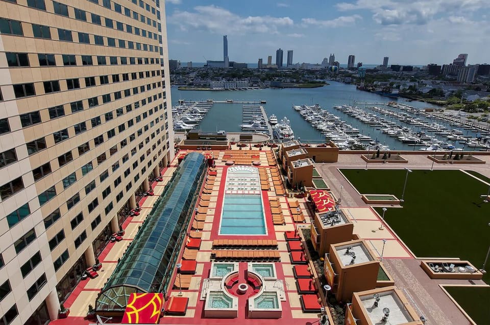 Soak up sunshine beside the rooftop pool with marina views.
