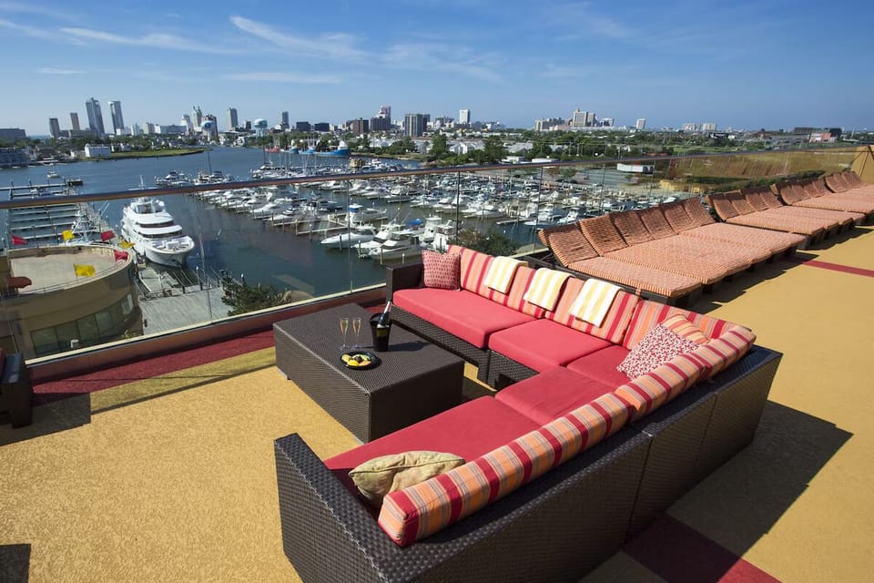 Unwind above the marina with panoramic skyline sunsets.
