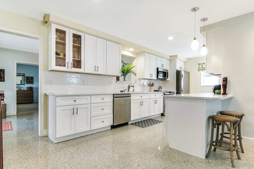 The bright, cheerful kitchen offers ample space & all the comforts of home