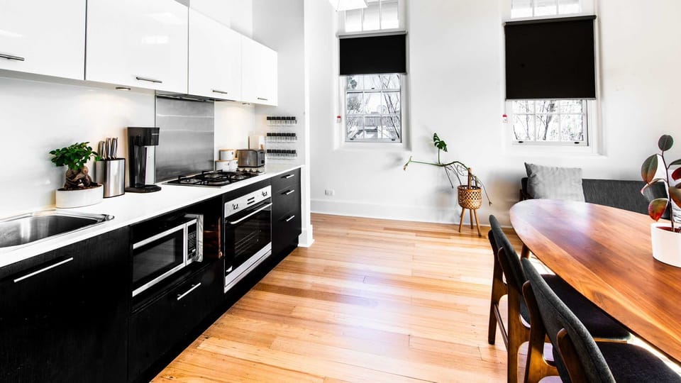 Stylish chef’s kitchen featuring premium finishes and polished timber floors