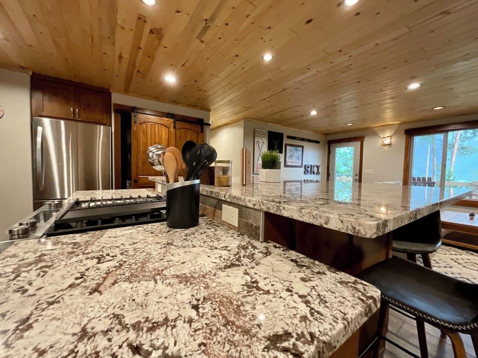 Beautiful kitchen with large granite bar and bar sitting.
