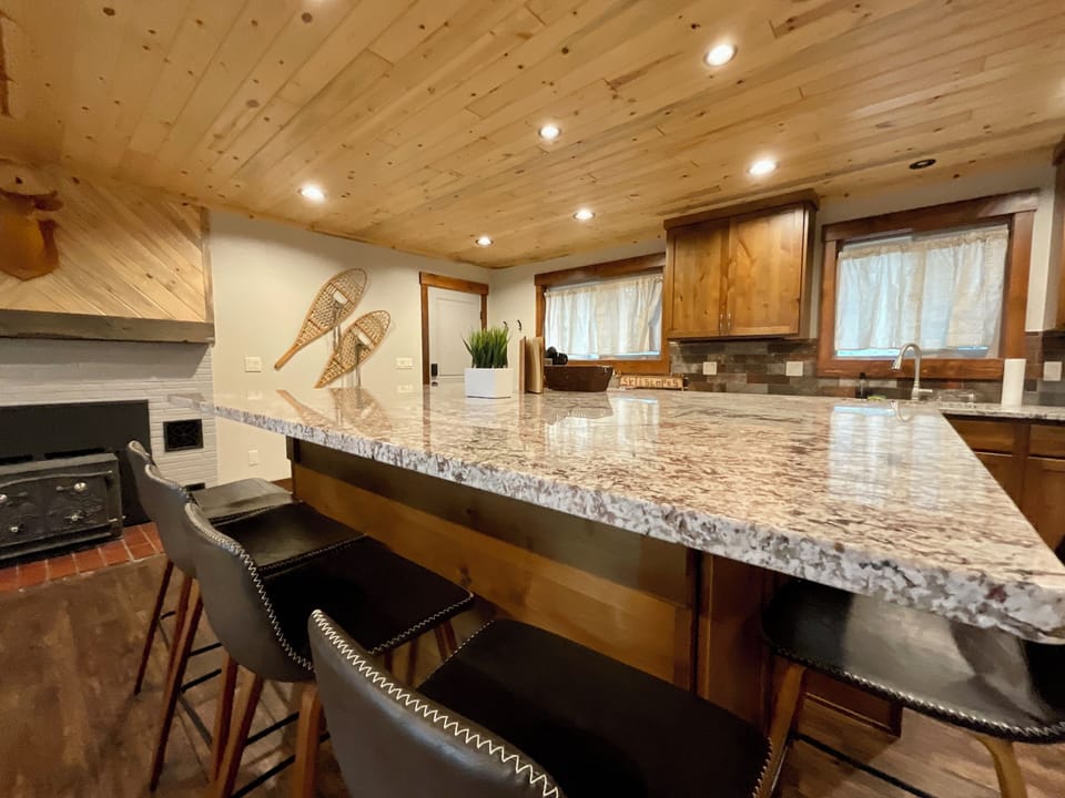 Beautiful kitchen with large granite bar and bar sitting.