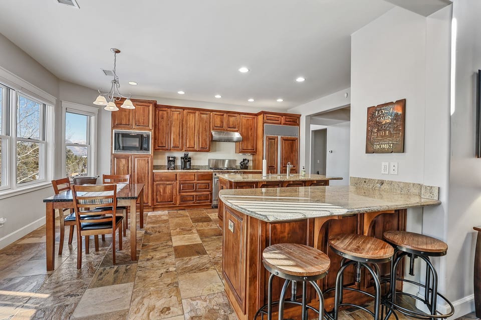 The open layout flows seamlessly into a fully equipped gourmet kitchen and elegant dining room, ideal for shared meals and lively conversations.