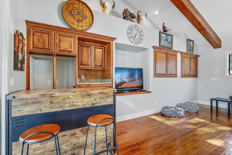 Featuring a full-sized pool table, bar area, loveseat, and flat-screen cable TV. This space also offers access to a private balcony overlooking the front yard, making it perfect for group fun and connection.