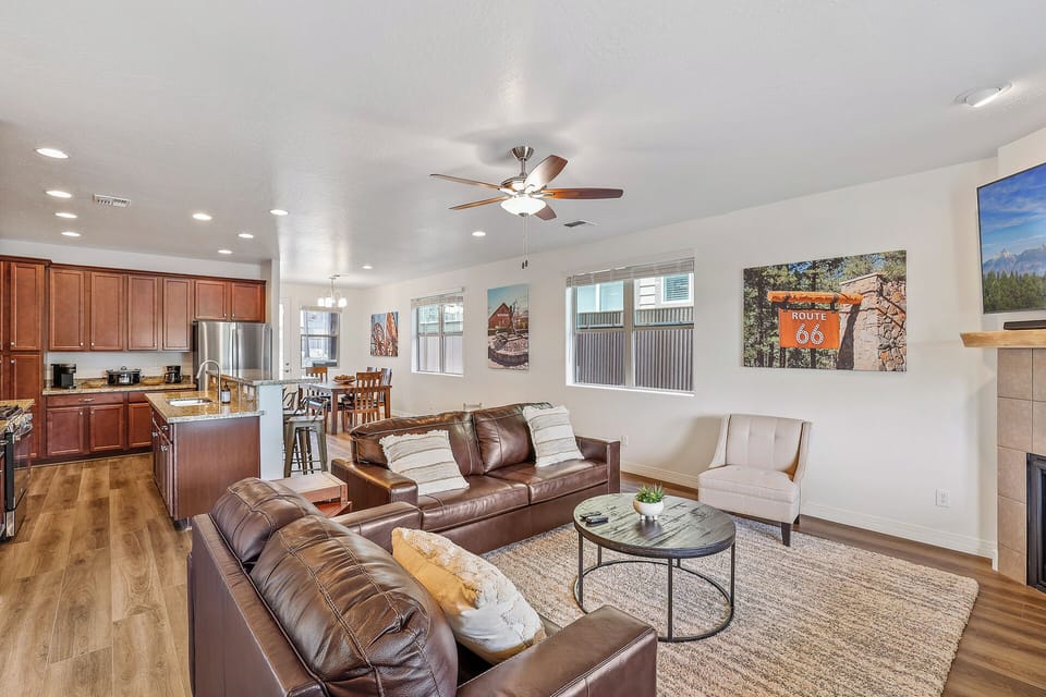 Main Living Area: Relax in style with two plush leather sofas, a cozy side chair, and a large flat-screen TV—perfect for movie nights or unwinding after a long day.