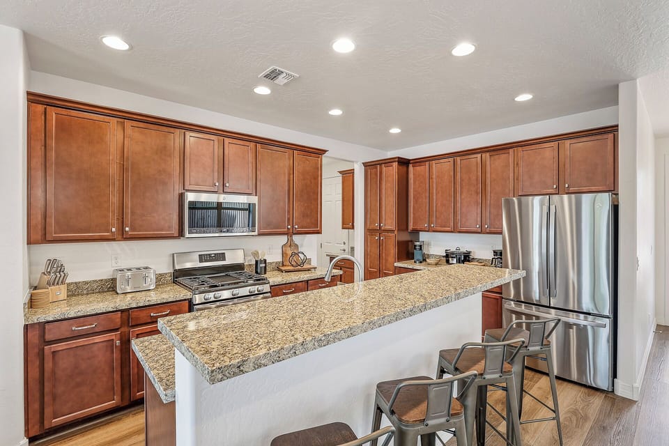 A kitchen nook with seating for 6, a kid-friendly table for 2, and 4 additional bar stool seats at the elevated counter.