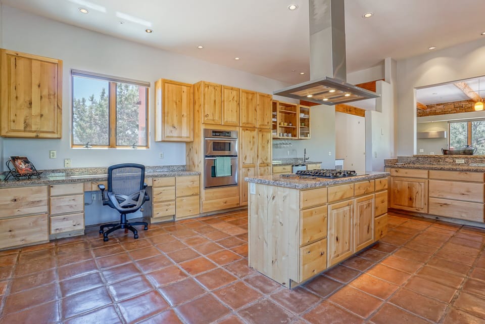 Fully Equipped Chef's Kitchen: Granite countertops, kitchen island, stainless steel appliances, gas range, double oven and everything you need to prepare a gourmet meal