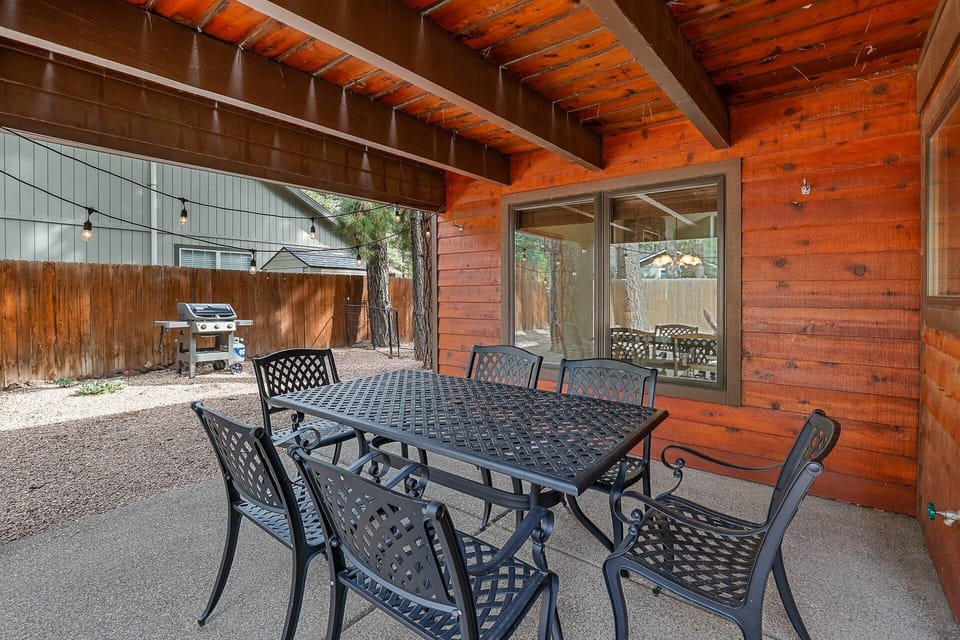 Outdoor Entertaining: Unwind in the private backyard in pines, featuring a firepit, comfortable seating for six, and a propane grill—perfect for shared meals or tranquil evenings in a peaceful neighborhood.