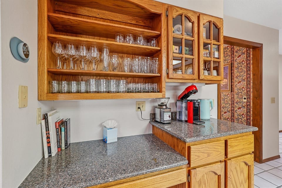 Modern gadgets galore: a KitchenAid mixer for your baking adventures, a Nespresso coffee maker to fuel your mornings, a coffee bean grinder, electric tea kettle, toaster, knife set, and more.