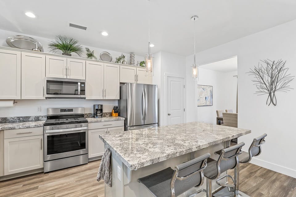 Step into this modern kitchen, featuring updated appliances for a seamless cooking experience.