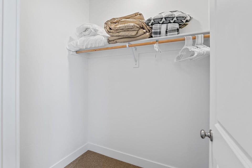 2nd Floor: Secondary Suite 2 (Queen Bed) - En-suite bathroom with premium amenities.