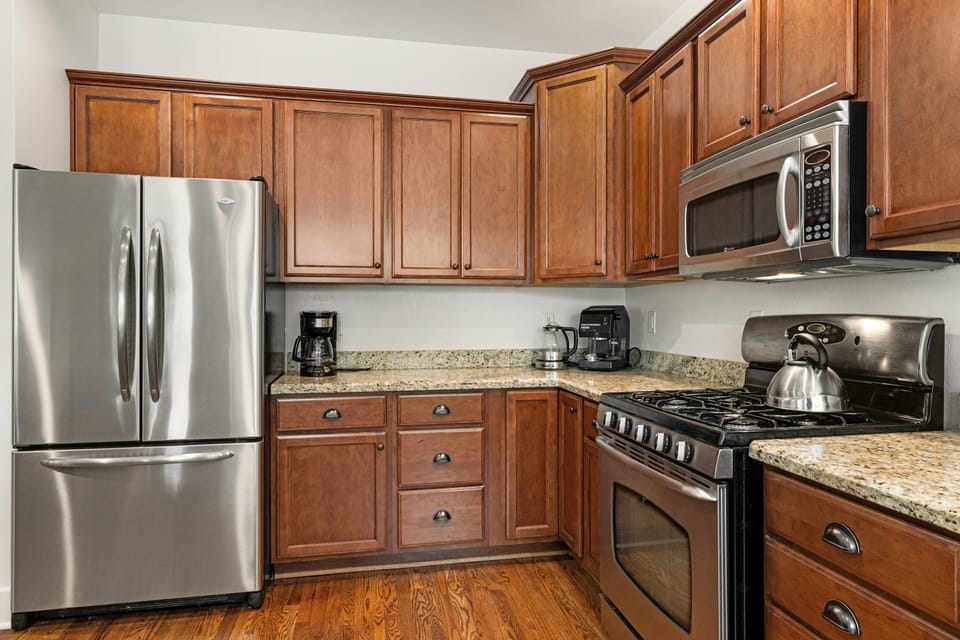 Fully stocked kitchen with cookware and utensils