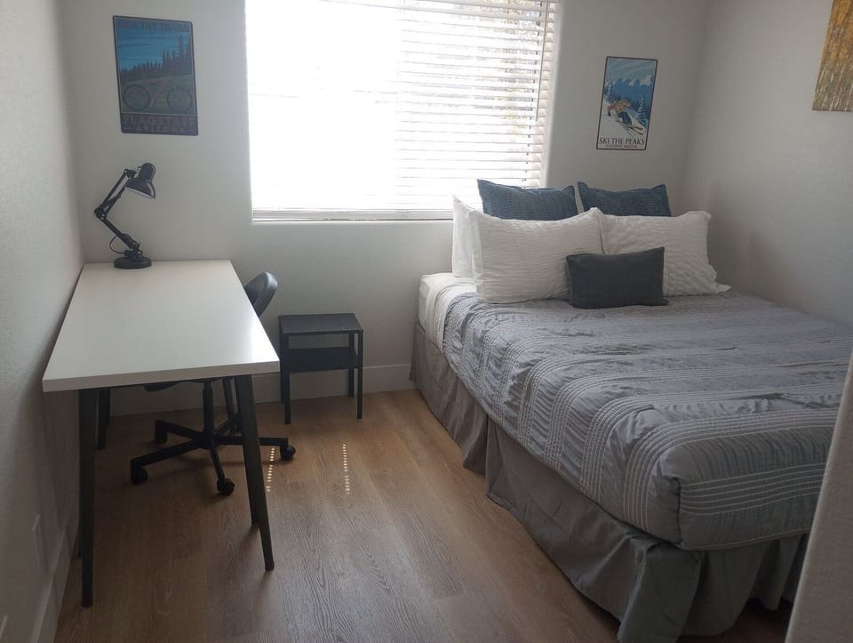 Guest Bedroom 2: bed, desk, and chair for remote work.