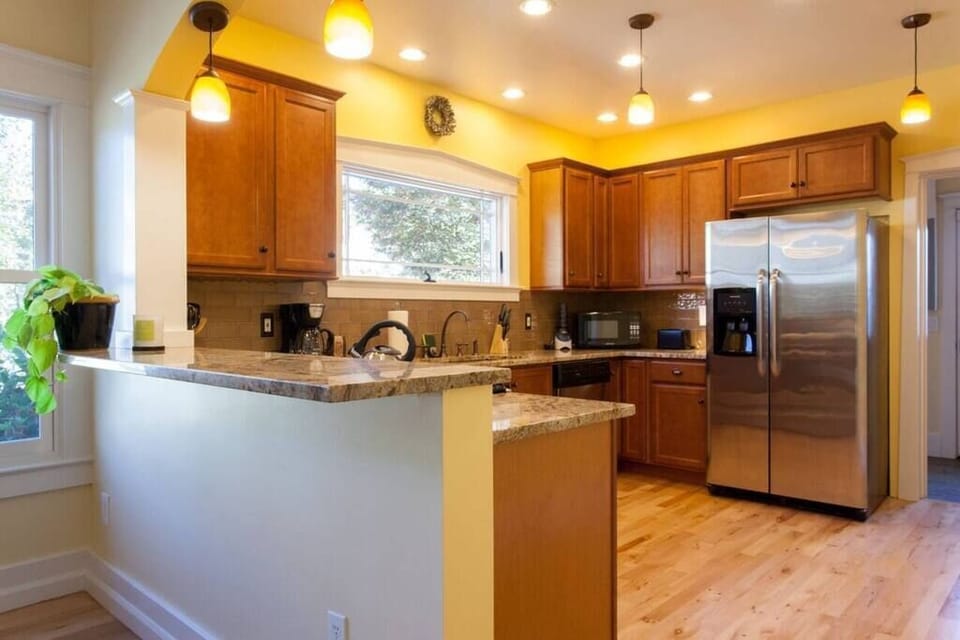 This recently renovated gourmet kitchen has gorgeous stainless-steel accessories and marble-slab countertops. 