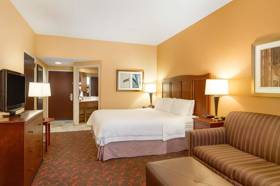 Wake up refreshed in a bright room with workspace nearby.
