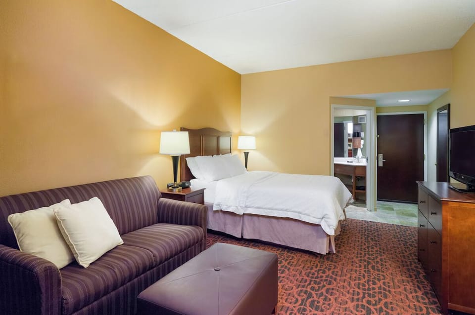 Stretch out and relax with roomy seating beside the bed.