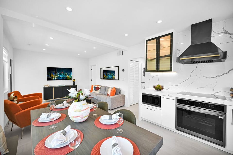 "Stylish open layout with modern kitchen and vibrant living area decor."