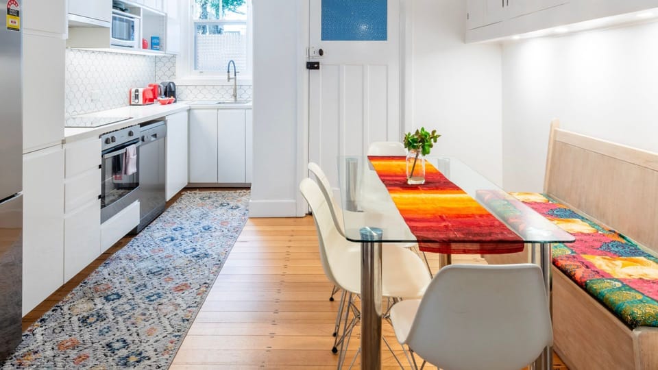 Bright kitchen and dining nook with colourful accents and casual seating