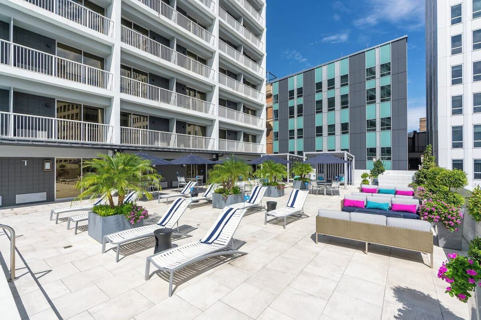 Unwind on stylish loungers with skyline views and breezy comfort.