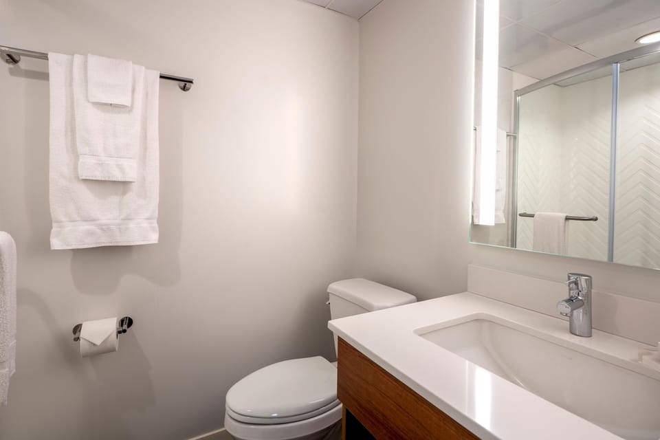 Refresh easily with a sleek vanity and bright, modern shower.