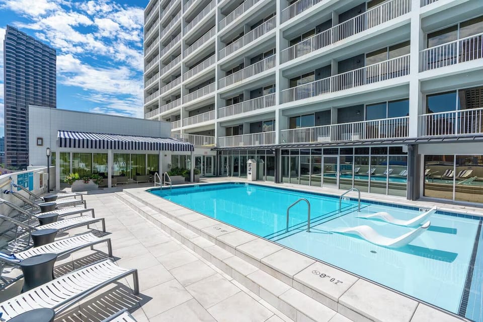 Dive into a sunlit rooftop pool for instant relaxation.