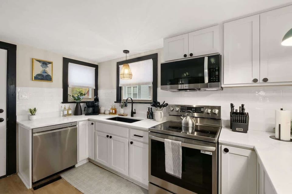 Fresh kitchen corner w/ sleek appliances, bright counters & plenty of prep space