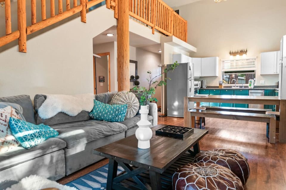Open-concept living space w/ hardwood floors & relaxed seating that flows into the kitchen.