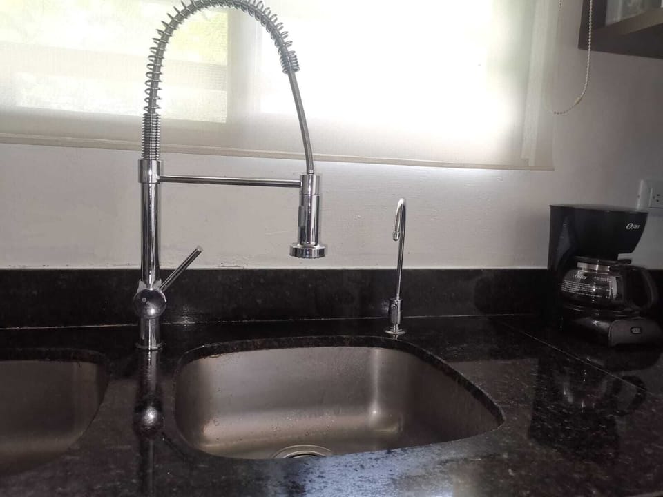 The small faucet is for the drinking water dispenser, that is connected to a 20Lts water jug below.