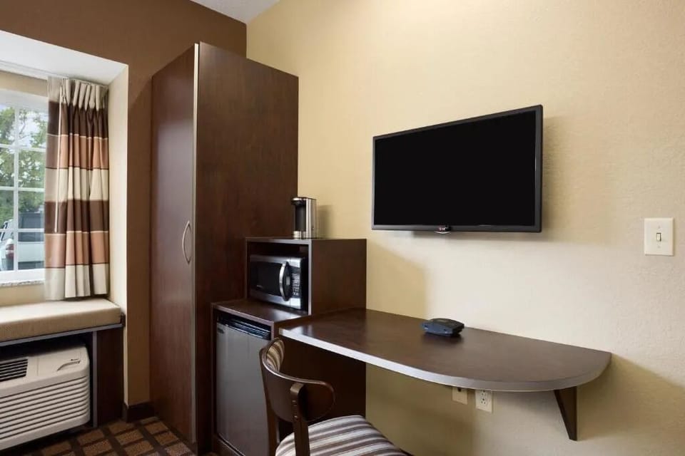 Settle in with handy microwave, mini-fridge, and workspace.