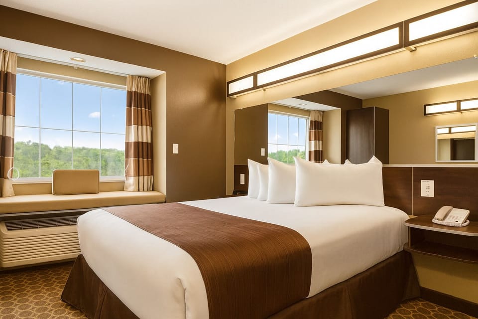 Sink into a plush king bed under warm, relaxing lights.