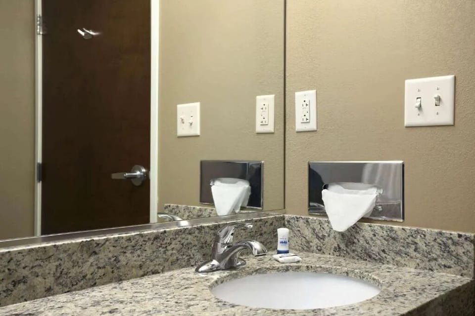 Start your day at a bright granite vanity and mirror.