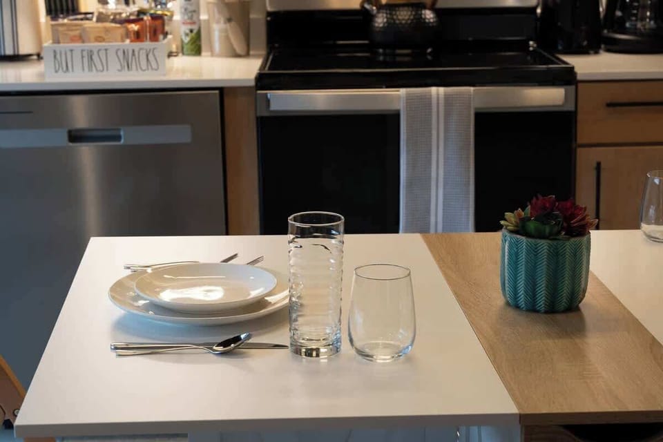 Dining setup beside the kitchen with plates and glasses