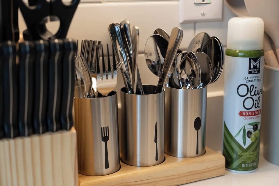 Cutlery and cooking utensils organized on kitchen counter