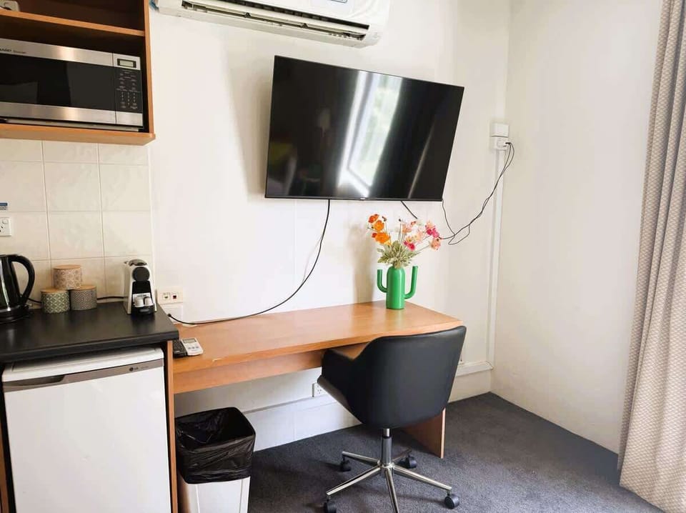 Stay connected and entertained! This dedicated workspace features a comfortable chair and a large smart TV, perfect for remote work, streaming, or catching up on your favorite shows.