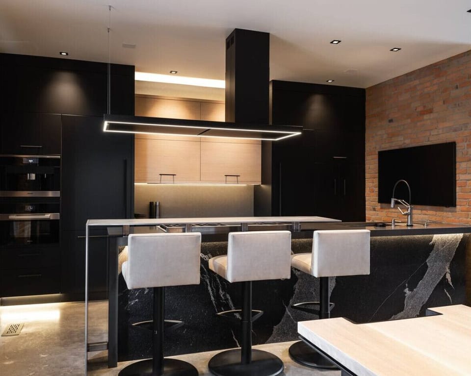 RH | Indulge in the sleek elegance of our fully equipped kitchen, featuring contemporary design and state-of-the-art amenities, perfect for preparing gourmet meals during your luxurious stay.