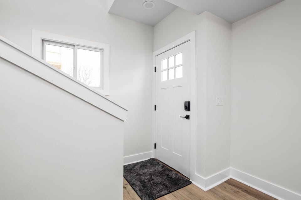 Entryway: Modern design meets inviting charm with natural light and smart locks for easy access!
