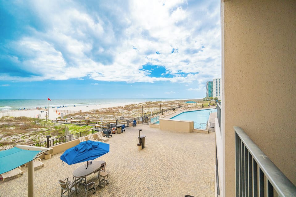 Poolside chatter and distant shore sounds blend as you relax on your balcony under open sky