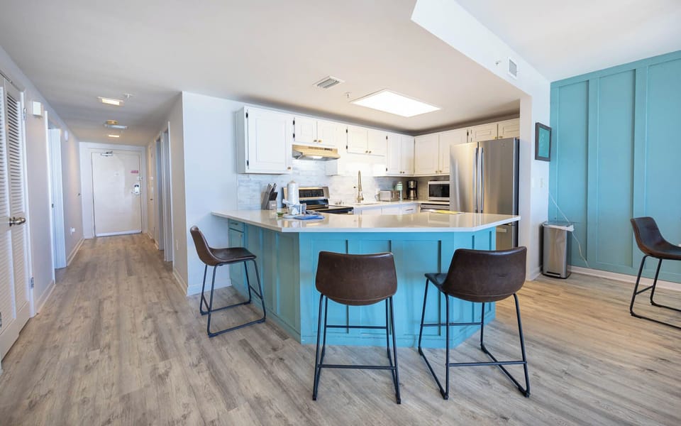 Gather around the spacious kitchen with stylish seating, perfect for meals and conversation