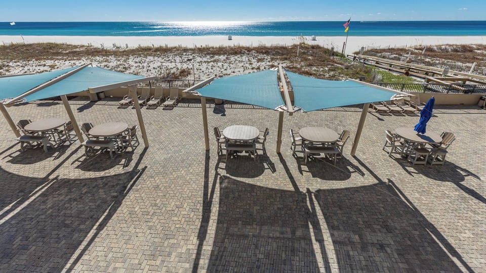 Relax beachfront overlooking the shaded cabanas around the outdoor pool area with a beachfront view
