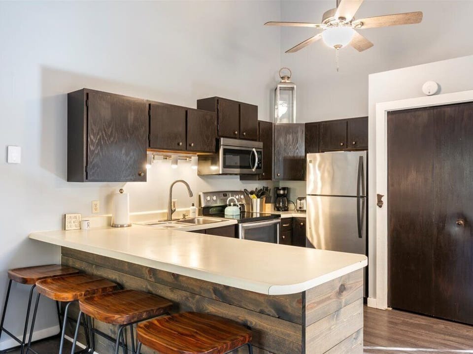 Kitchen has bar stools for extra seating