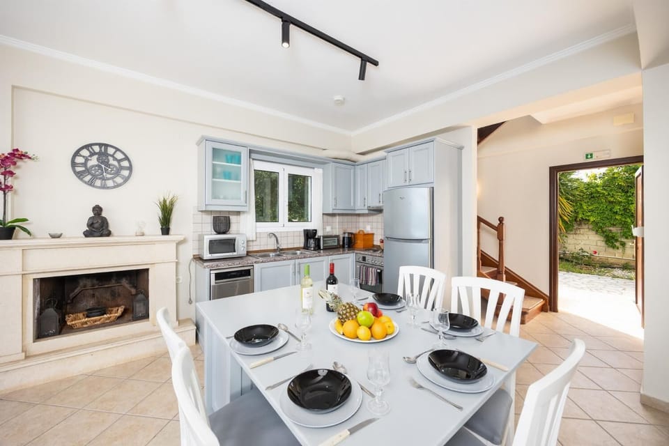 Open-plan living room with sofa, dining area, kitchen, WiFi internet, satellite TV, and sea views