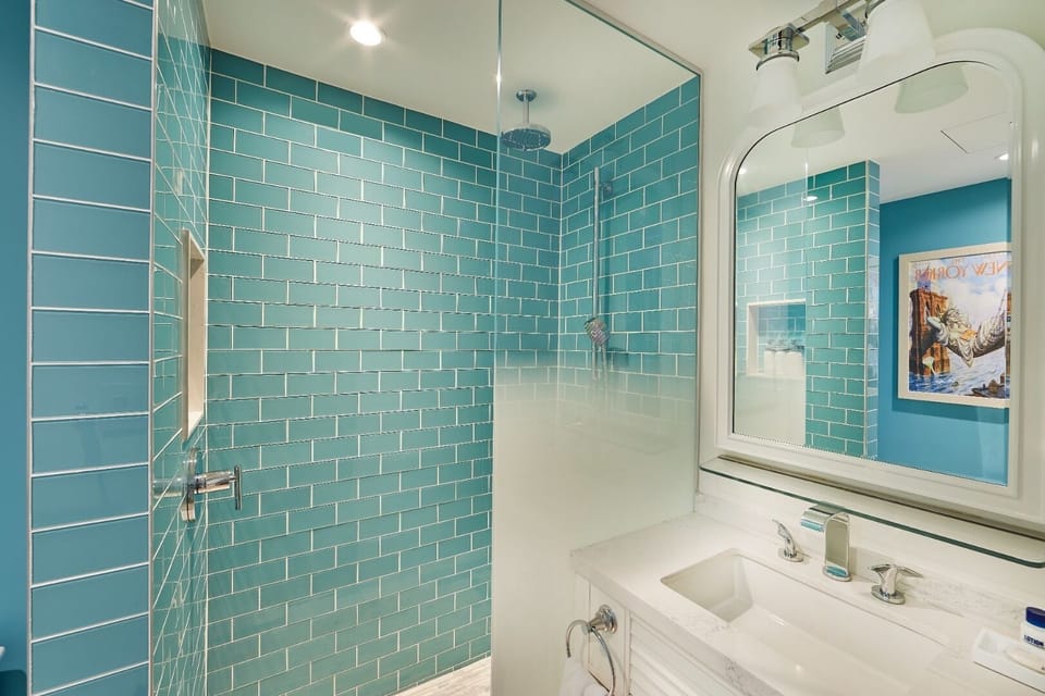 Refresh under a rain-style shower in sparkling turquoise tile.