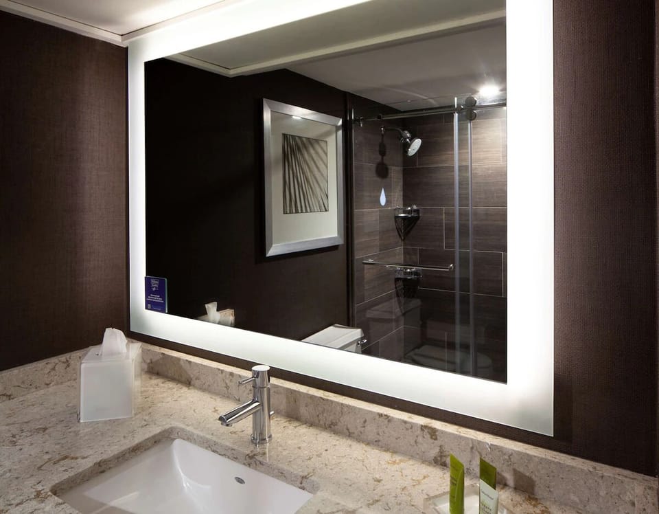 Start your morning at a sleek vanity with glowing mirror light.