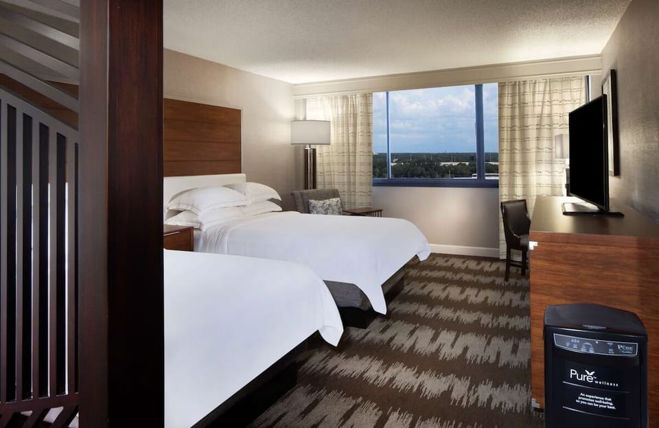 Unwind in crisp linens with calming views beyond the window.