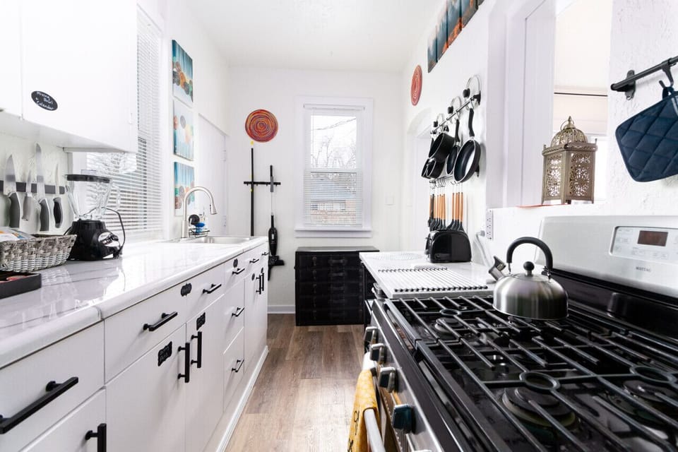 The kitchen's minimalist design features a mix of modern and vintage elements.